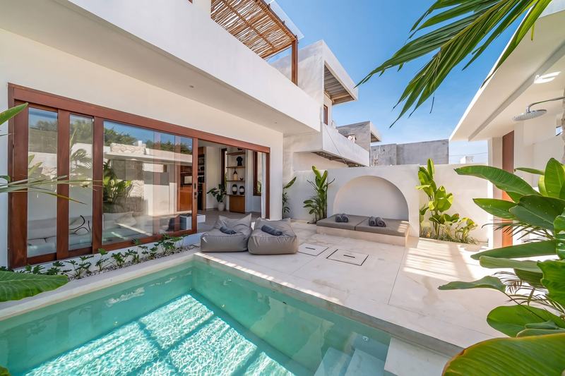 Three-bedroom villa in Nyang Nyang: pool with the living room behind glass