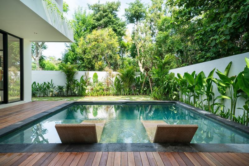 Three-bedroom villa in Nunggalan, Uluwatu: lawn and garden around the pool