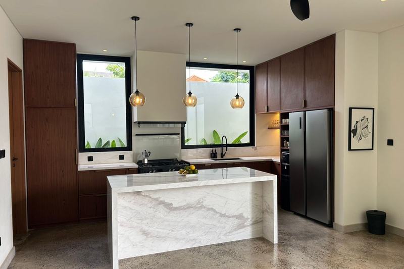 Four-bedroom villa with a study in Uluwatu: kitchen with a marble island and a garden window
