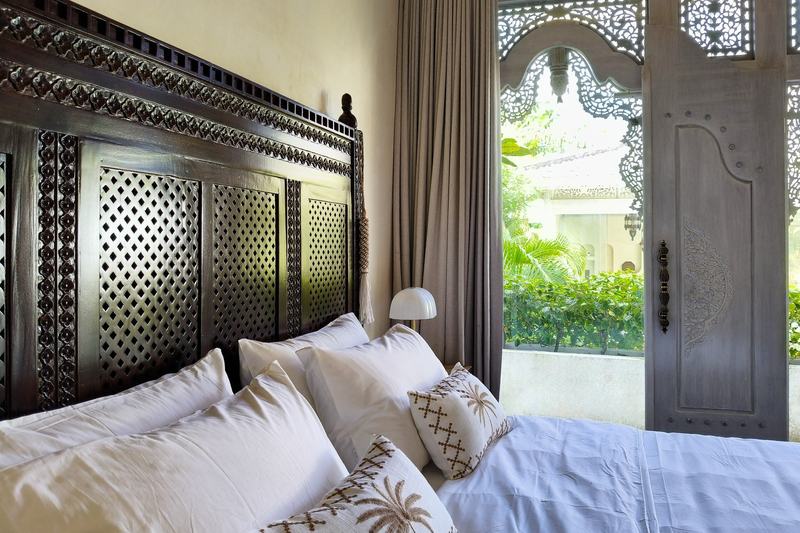 Villa with carved arches in Ungasan: headboard and carved doors