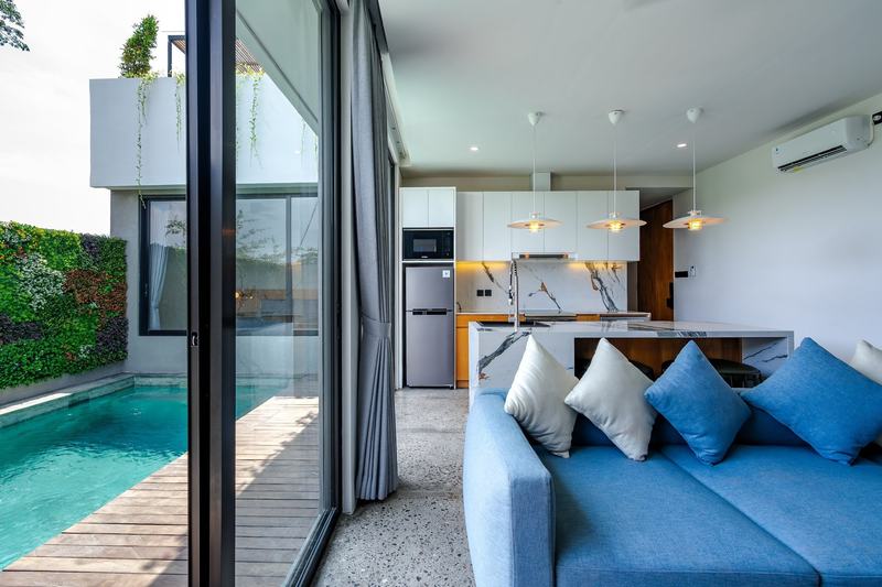 Two-bedroom villa in west Ungasan: living room and kitchen opening to the pool