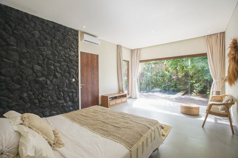 Villa in west Ungasan: bedroom with a stone feature wall