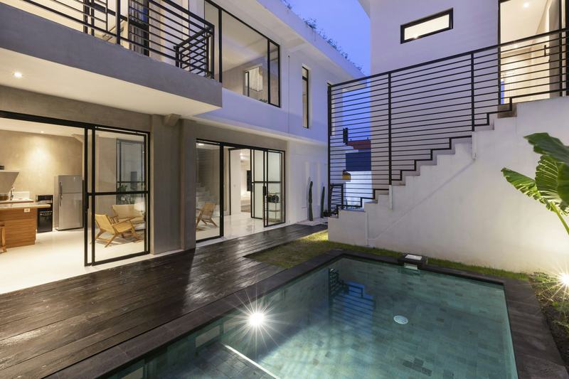 Modern Bali villa with a pool at dusk