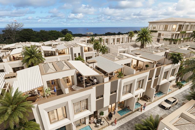 Rooftops and private pools of a villa complex near the ocean