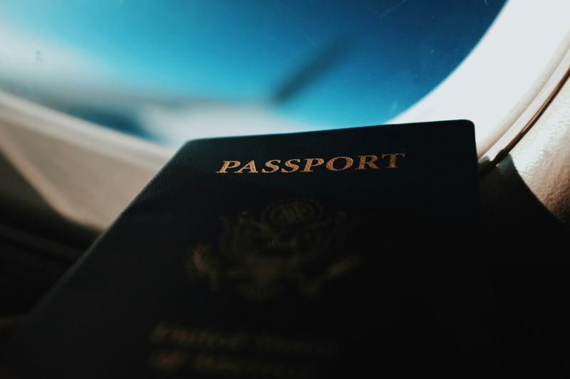 A passport held up against an airplane window