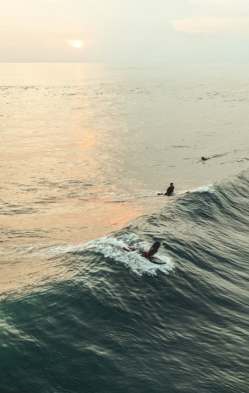 A surfer on a wave off the Bali coast