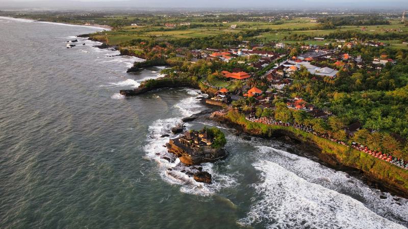 Tanah Lot temple and the Tabanan coastline from the air, a short drive up the shore from Nuanu