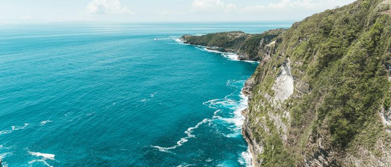 Rocky coastline above turquoise water, Bali
