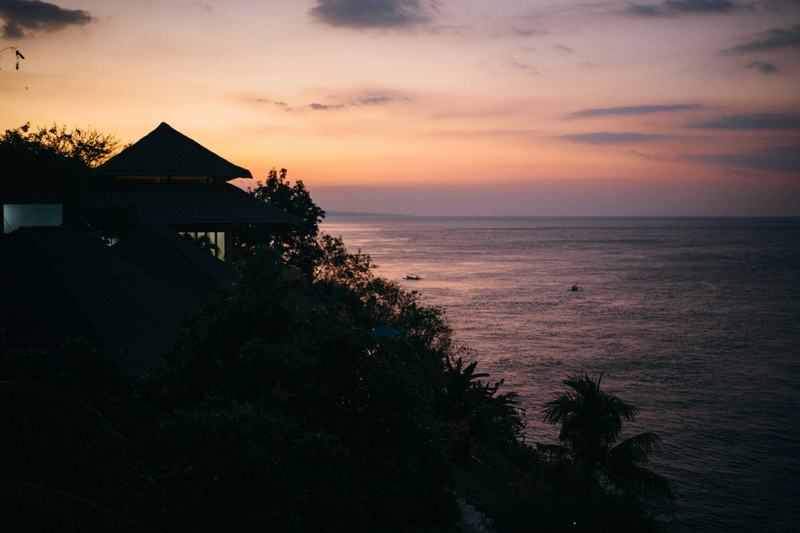 Sunset over the Bali Sea, seen from a clifftop pavilion
